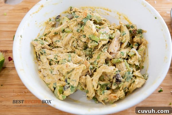 bowl of stirred curry chicken salad