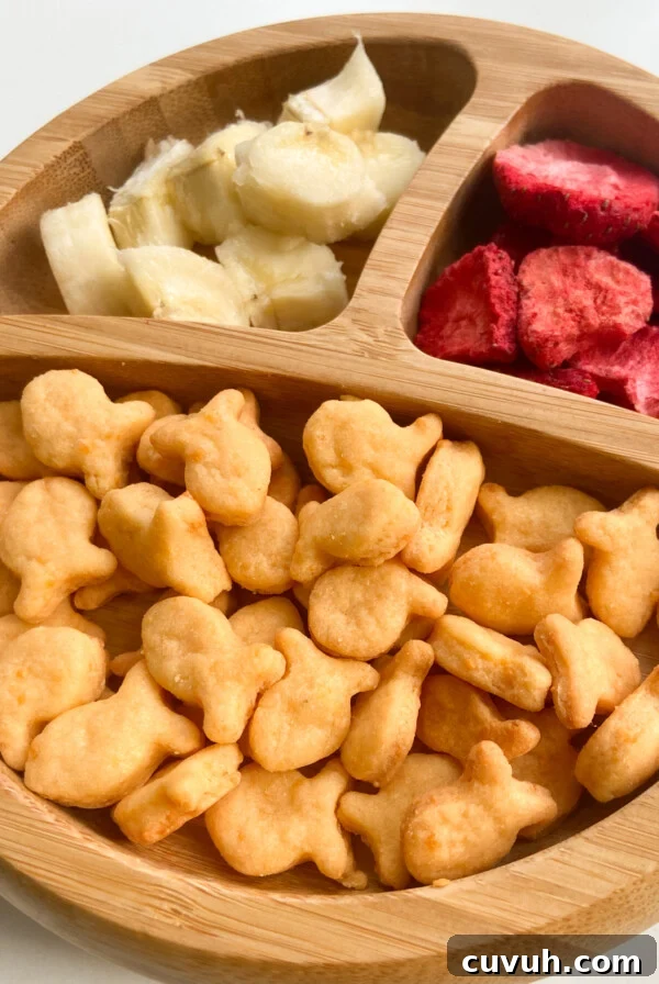Healthy homemade goldfish crackers served with bananas and freeze dried strawberries