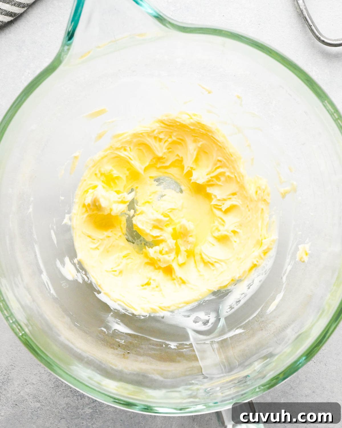 how to make raspberry frosting - beaten butter in a glass mixing bowl