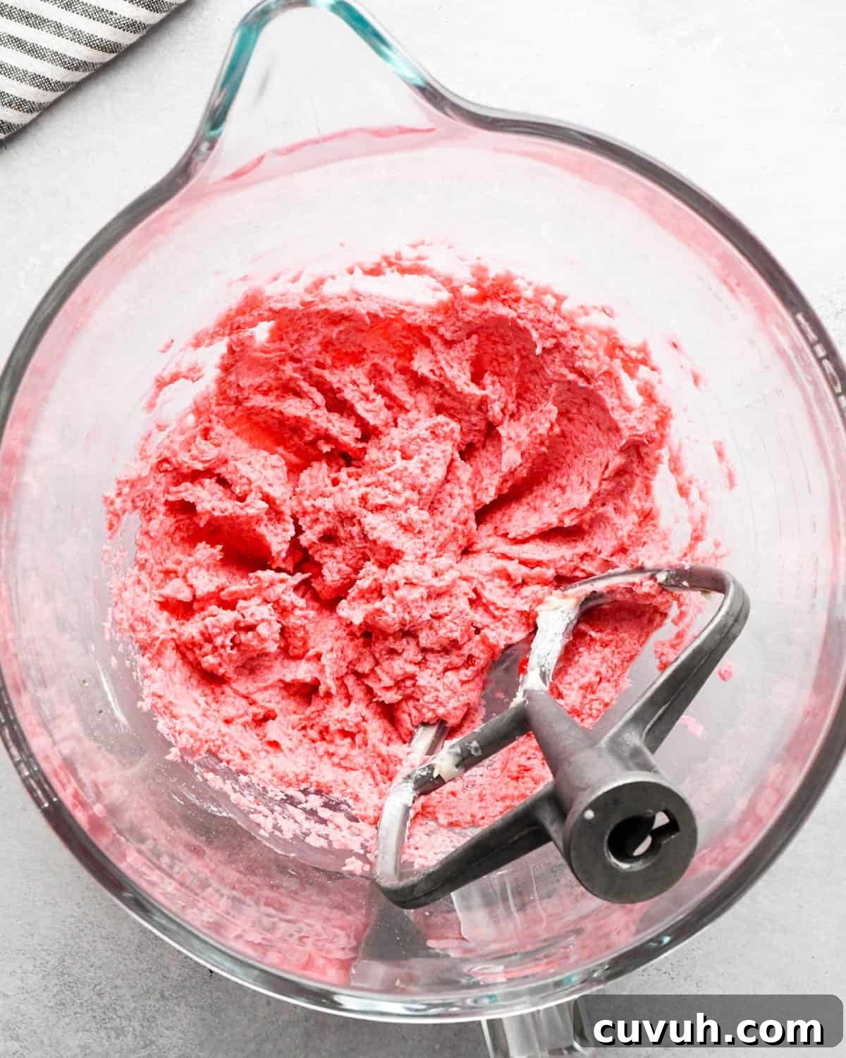 how to make raspberry frosting - ingredients after mixing with the paddle attachment in a glass bowl