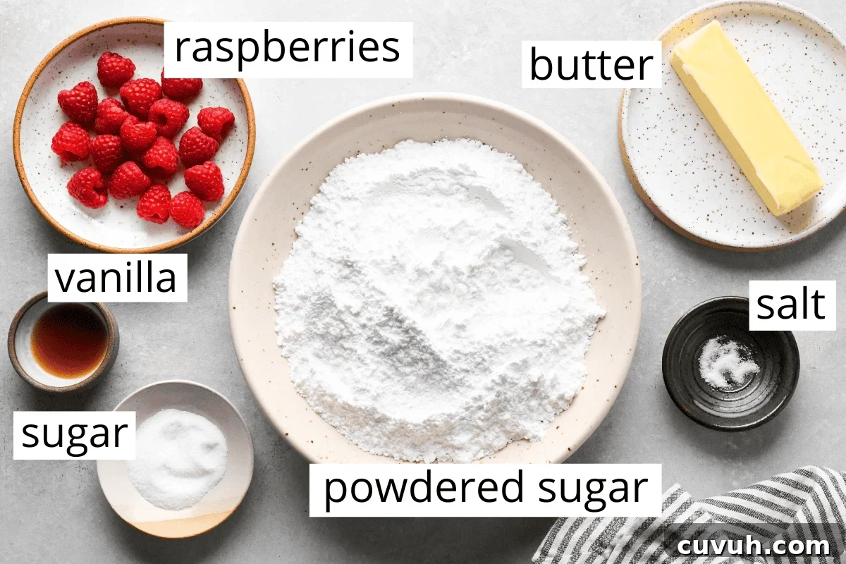 overhead photo of the ingredients in this raspberry frosting recipe all in bowls and labeled - butter, salt, powdered sugar, raspberries, vanilla and sugar 