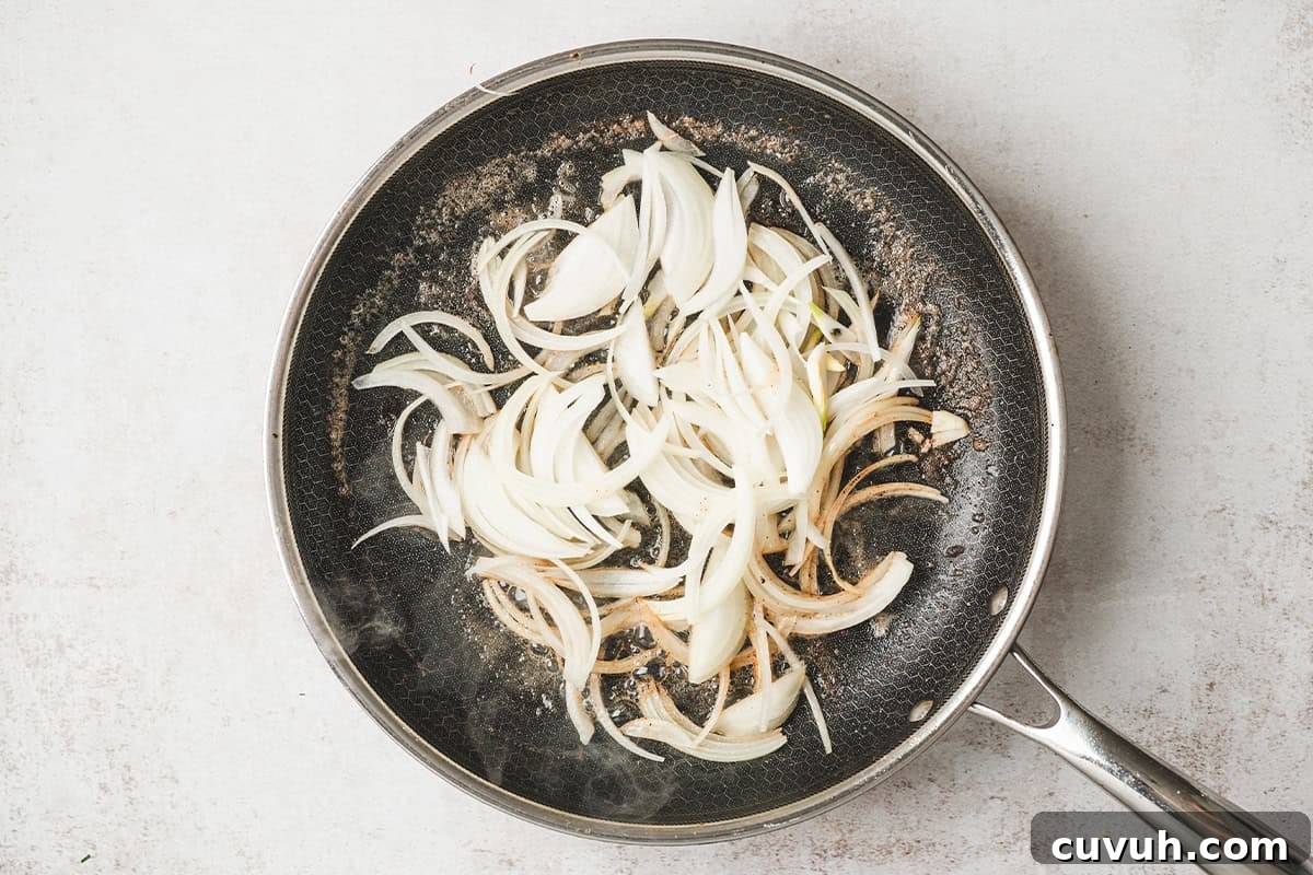 Sliced onions in a skillet.