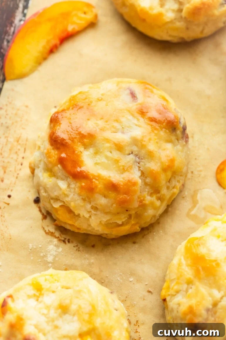 A flaky pastry sitting on parchment paper with fruit