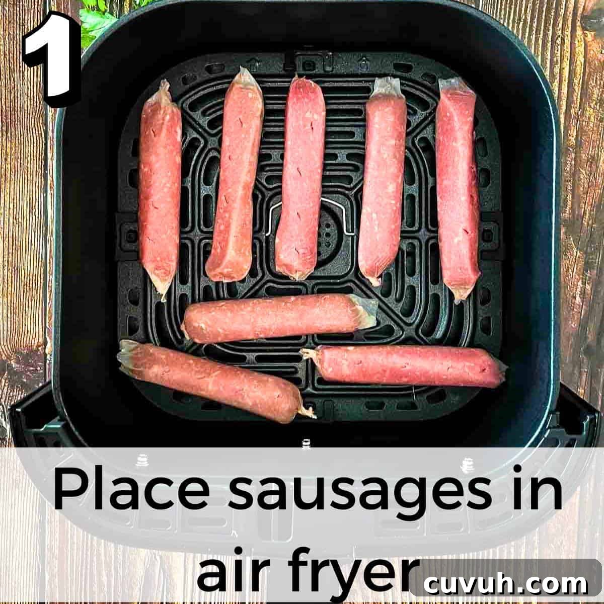 Crispy Juicy Air Fryer Breakfast Sausages in 15 Minutes 4 Breakfast sausages poked with a fork and placed in the air fryer basket in a single layer.