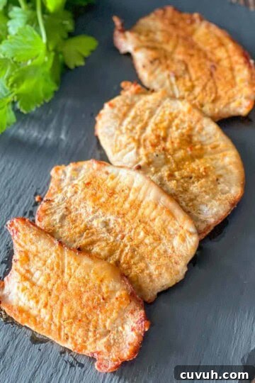 Thin air fried pork chops on a serving platter.