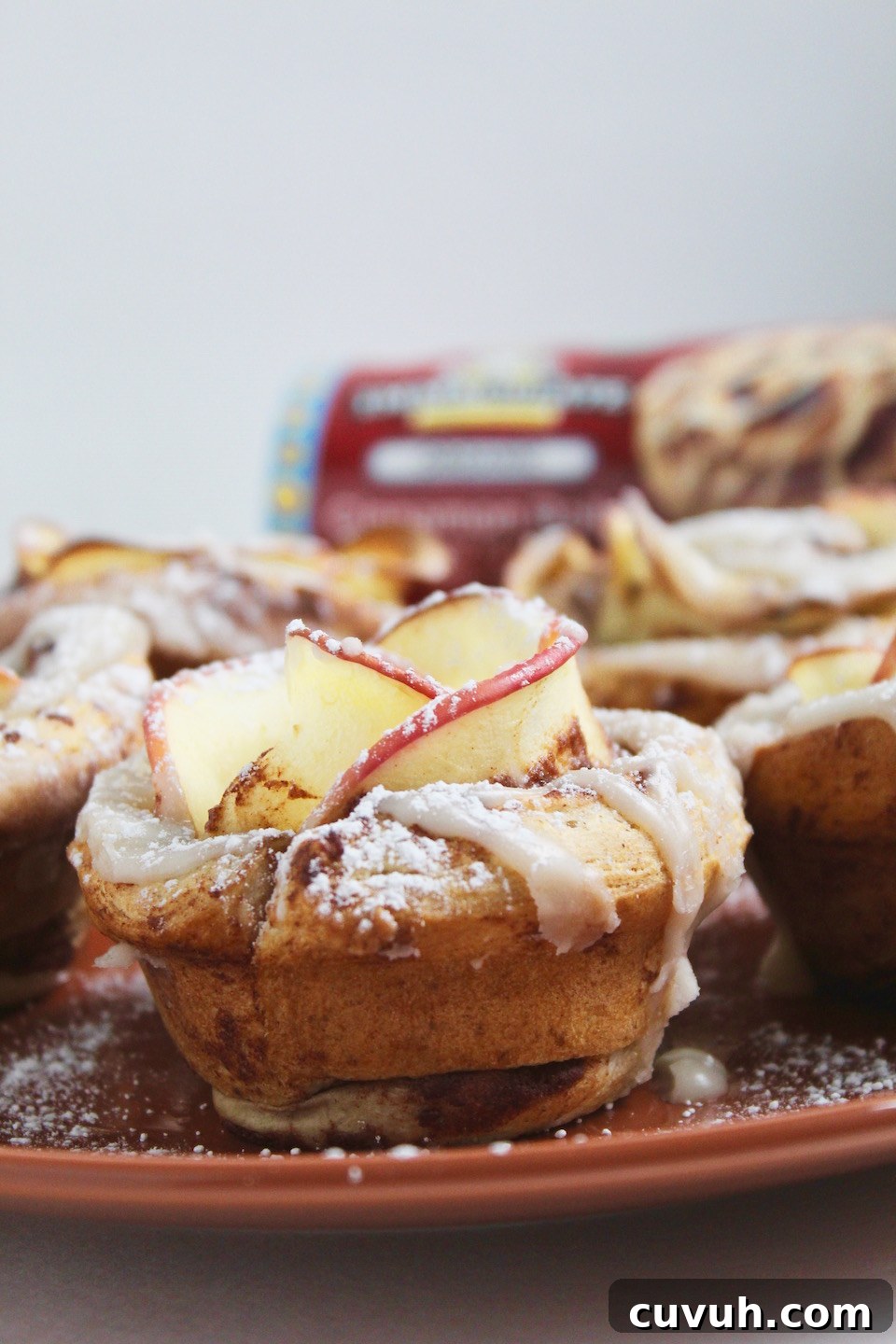 Cinnamon Roll Apple Roses Recipe -- Edible roses made with tart apple slices wrapped up in sweet and gooey cinnamon rolls.