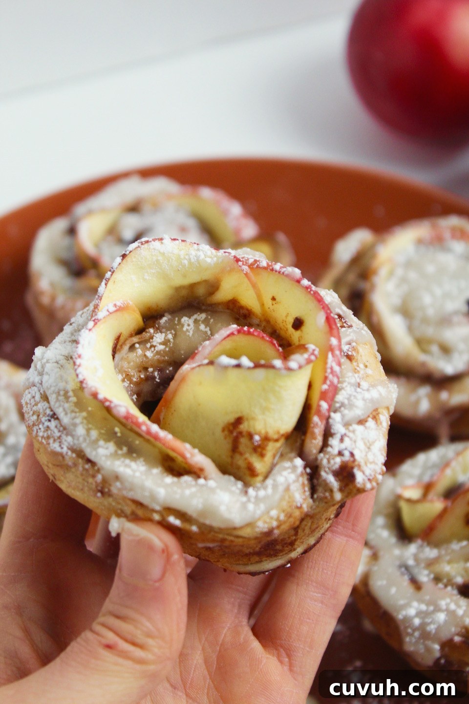 Cinnamon Roll Apple Roses Recipe -- Edible roses made with tart apple slices wrapped up in sweet and gooey cinnamon rolls.