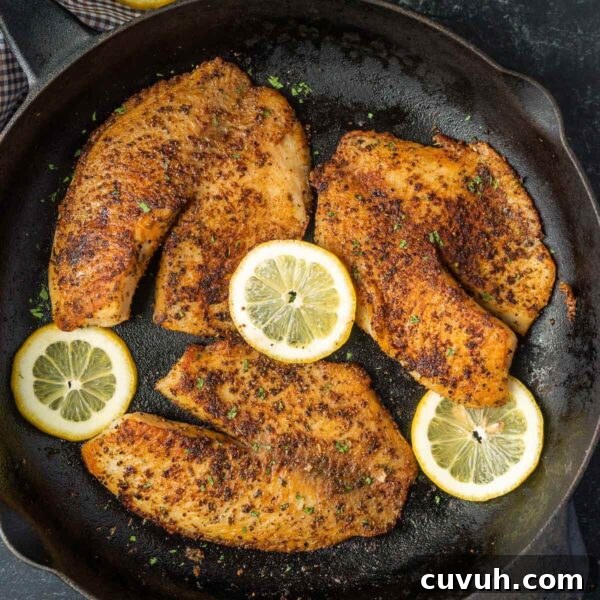 Perfectly Grilled Tuna Steaks: Marinade, Sear & Serving Tips 12 Tilapia in a cast iron skillet with slice lemons on the side