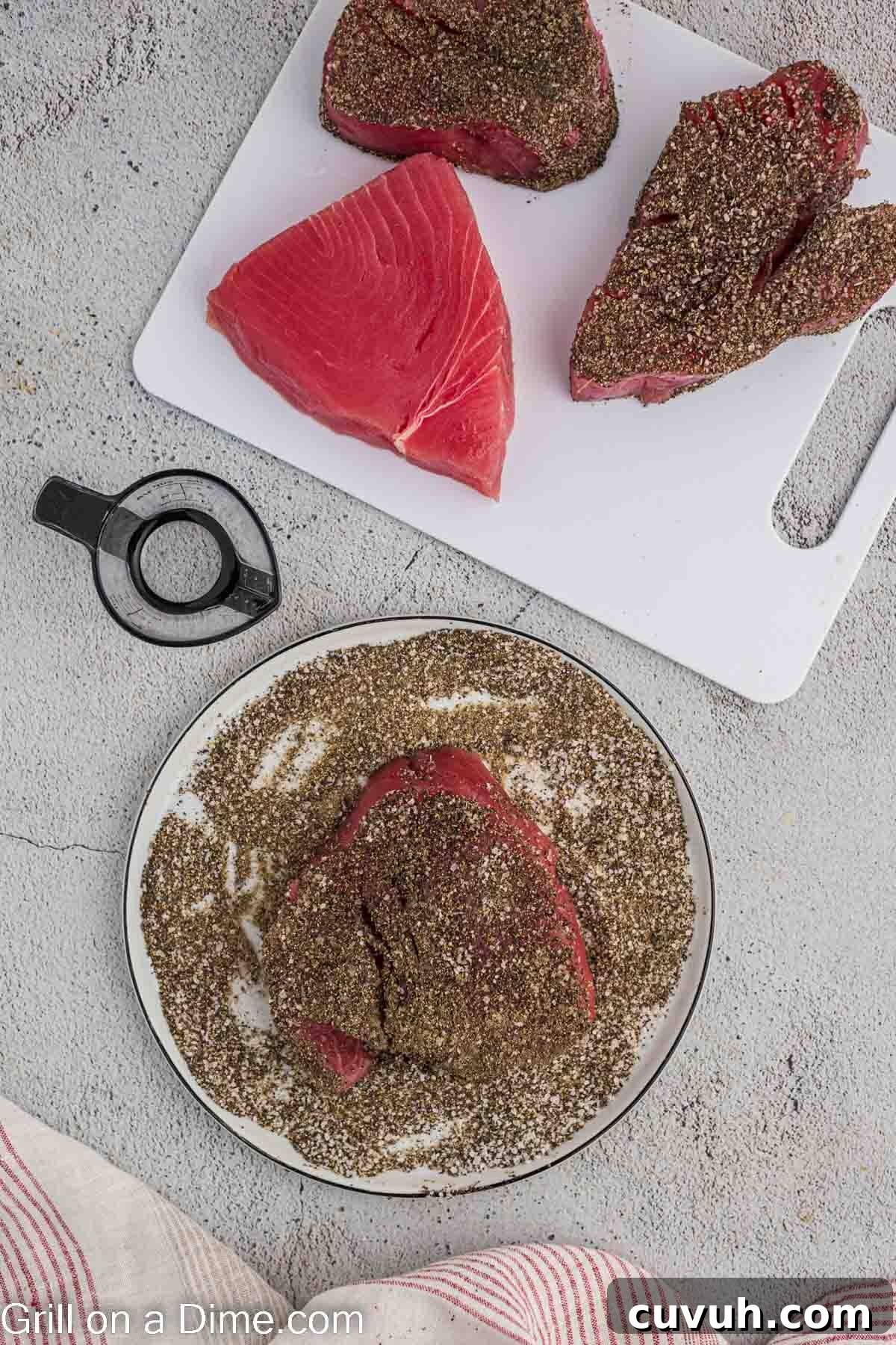 Perfectly Grilled Tuna Steaks: Marinade, Sear & Serving Tips 4 Seasoning the tuna steaks on a plate with 3 grilled steaks on a cutting board with 2 of them seasoned