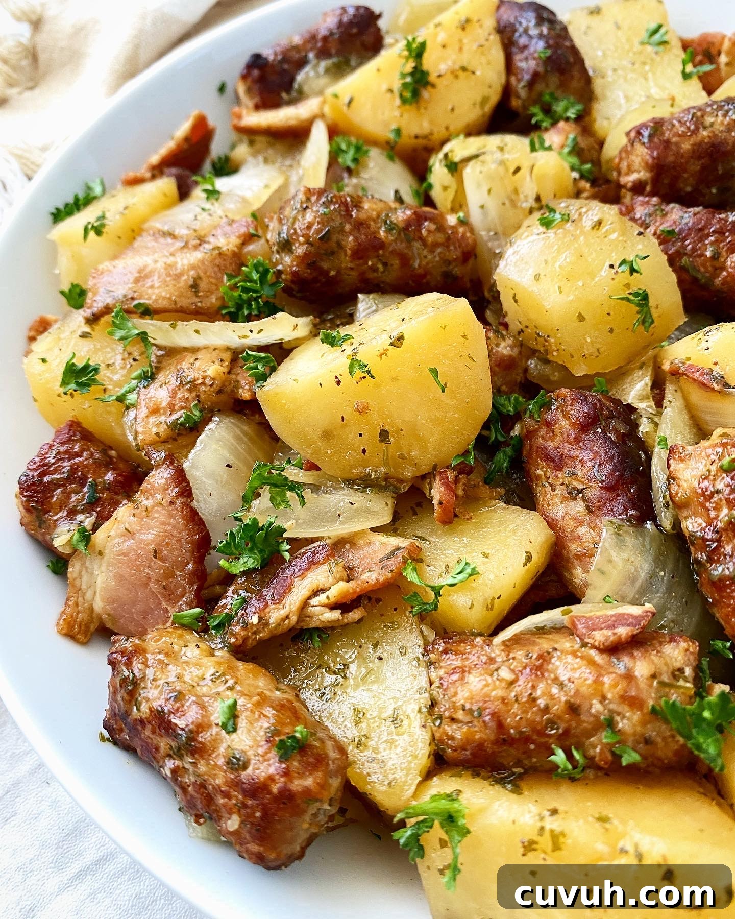 side view of irish dublin coddle in a white bowl