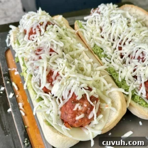 Smoked Meatball Subs Recipe: Flavorful Homemade Sandwiches 3 meatball sub with cheese on it