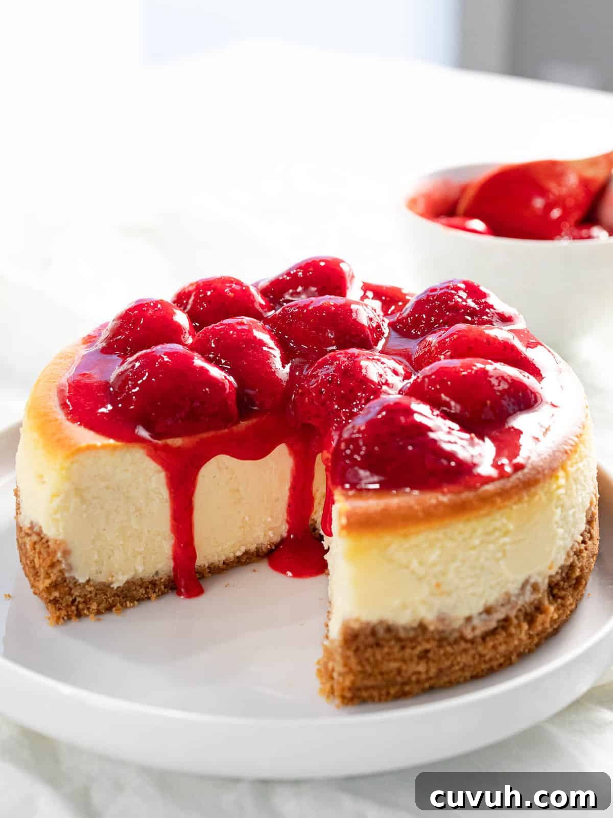 Decadent Strawberry Cheesecake Recipe with Fresh Berry Topping 13 Baked strawberry cheesecake with strawberry topping.