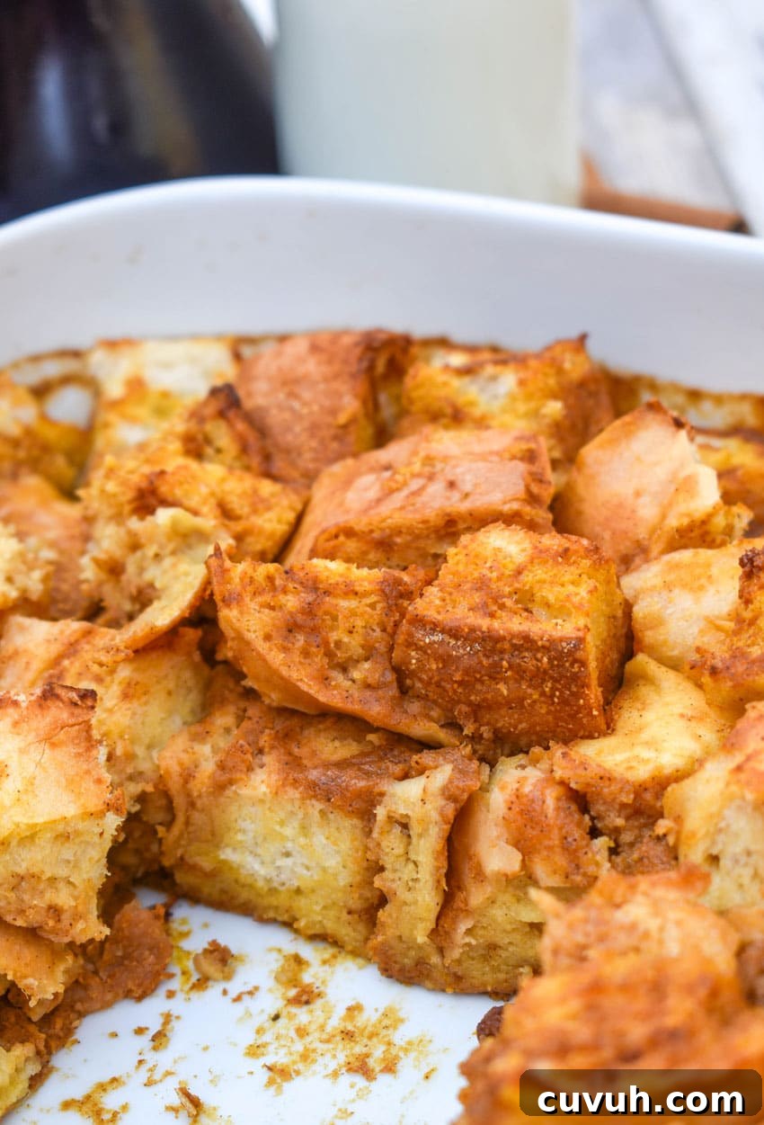 pumpkin bread pudding in a white baking dish