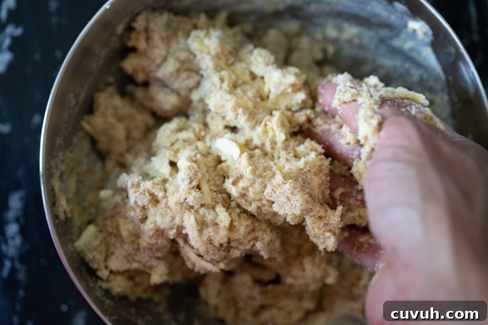 Keto Peach 'n' Cream Shortcake Recipe for Low-Carb Desserts 6 Mixing the keto shortcake dough with a hand in a gray bowl