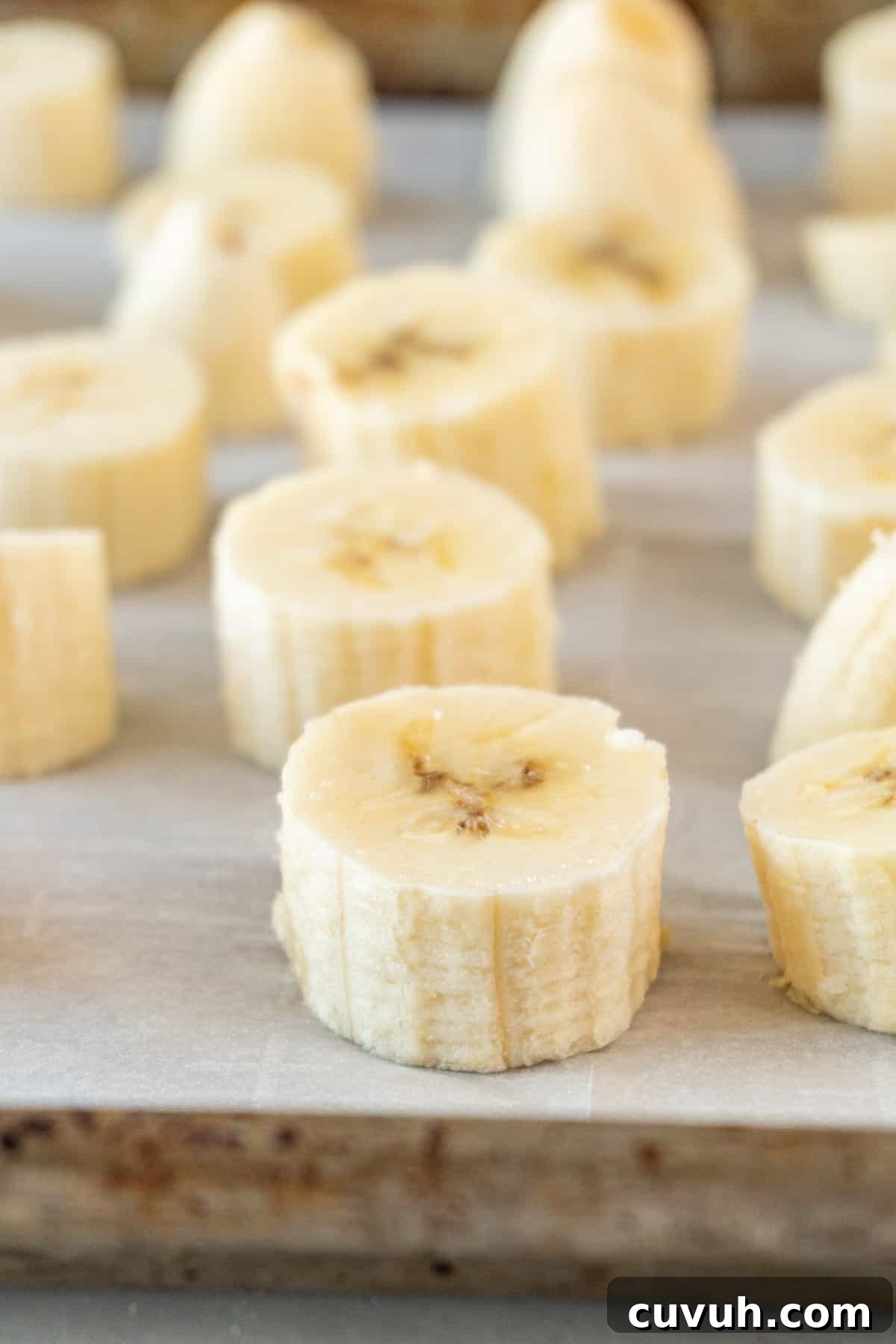 How to Freeze Bananas for Smoothies, Baking, and Snacks 2 sliced bananas on baking sheet