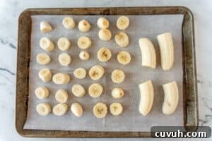 How to Freeze Bananas for Smoothies, Baking, and Snacks 17 sliced bananas on baking sheet