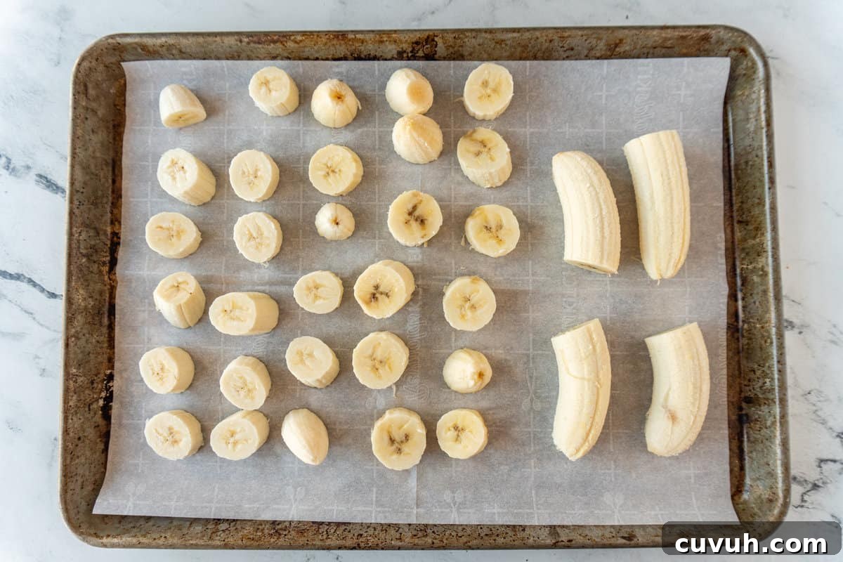 How to Freeze Bananas for Smoothies, Baking, and Snacks 5 sliced bananas on baking sheet