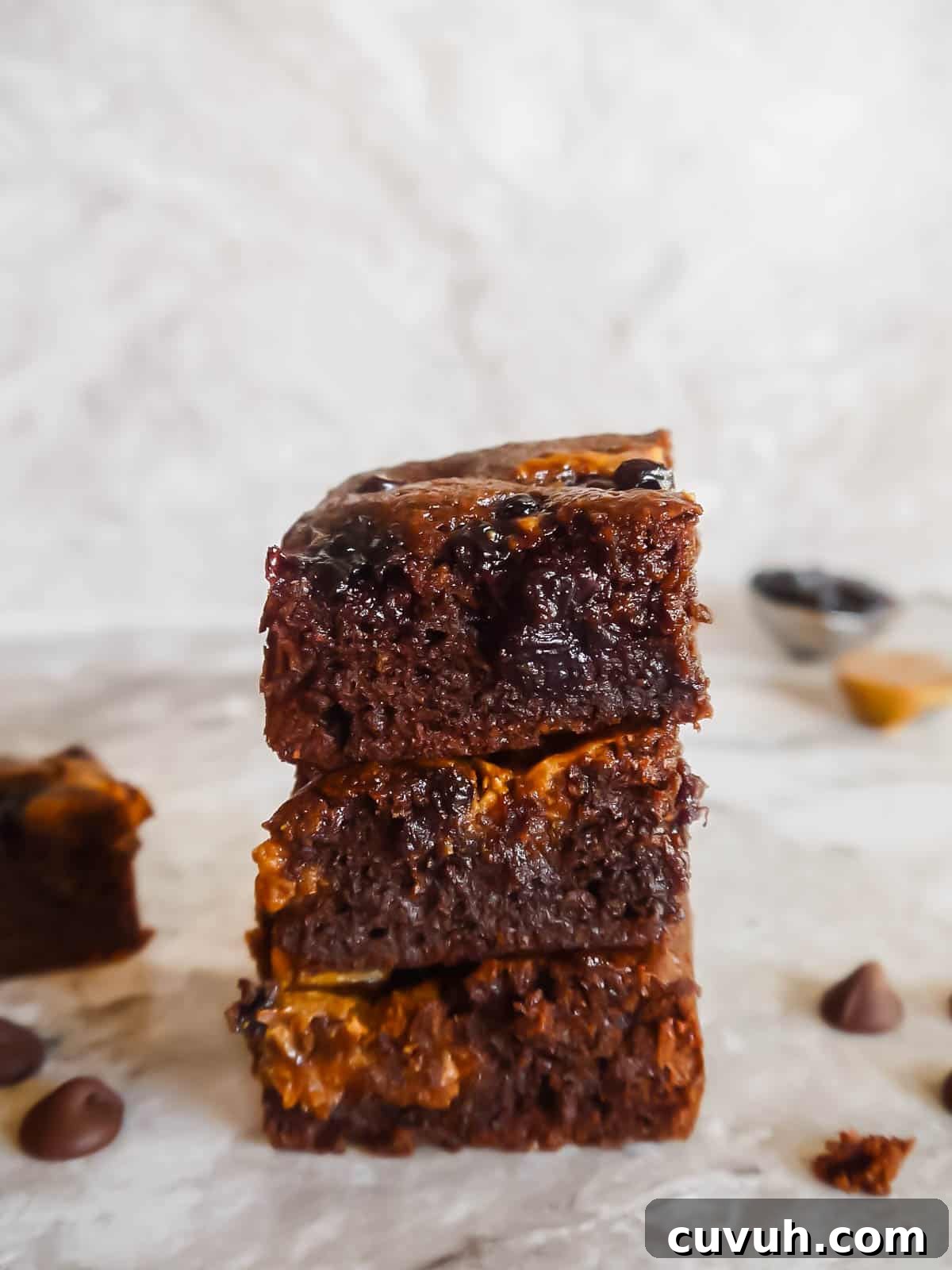 Paleo Almond Butter & Jelly Brownies — Gluten-Free Recipe 14 Almond flour brownies recipe with almond butter and jelly. Brownies stacked on top of each other.