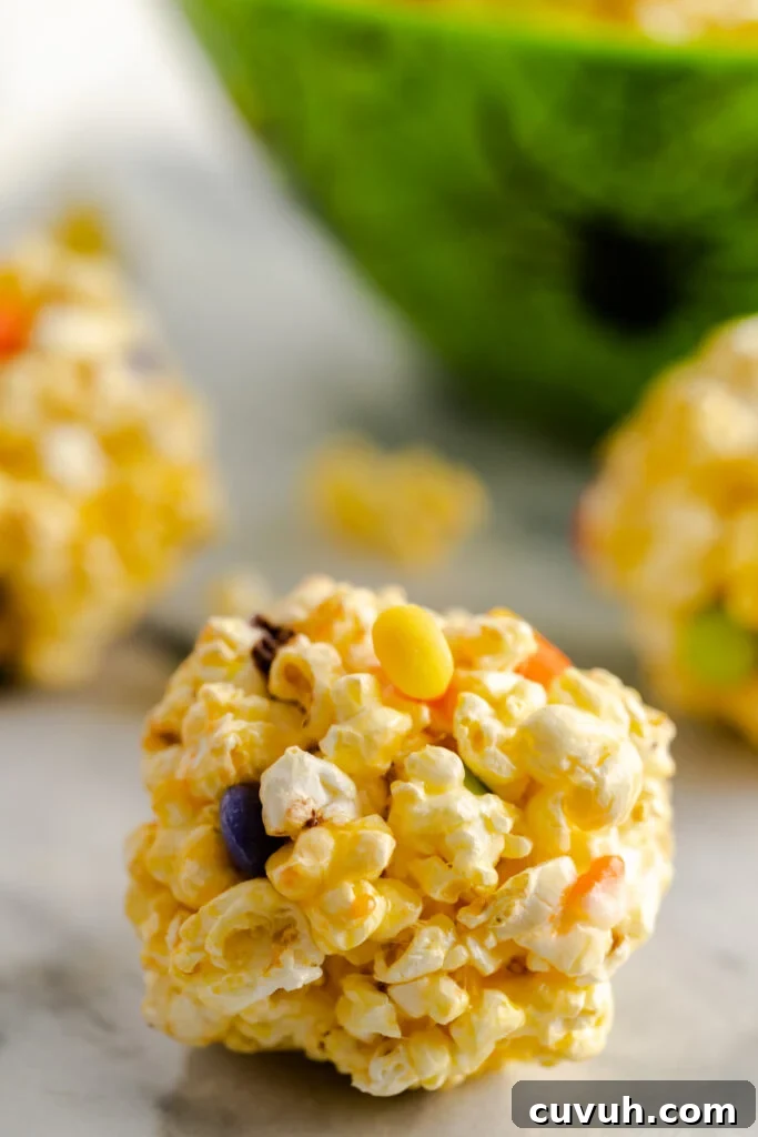 Candy corn popcorn balls with Halloween M&M's.