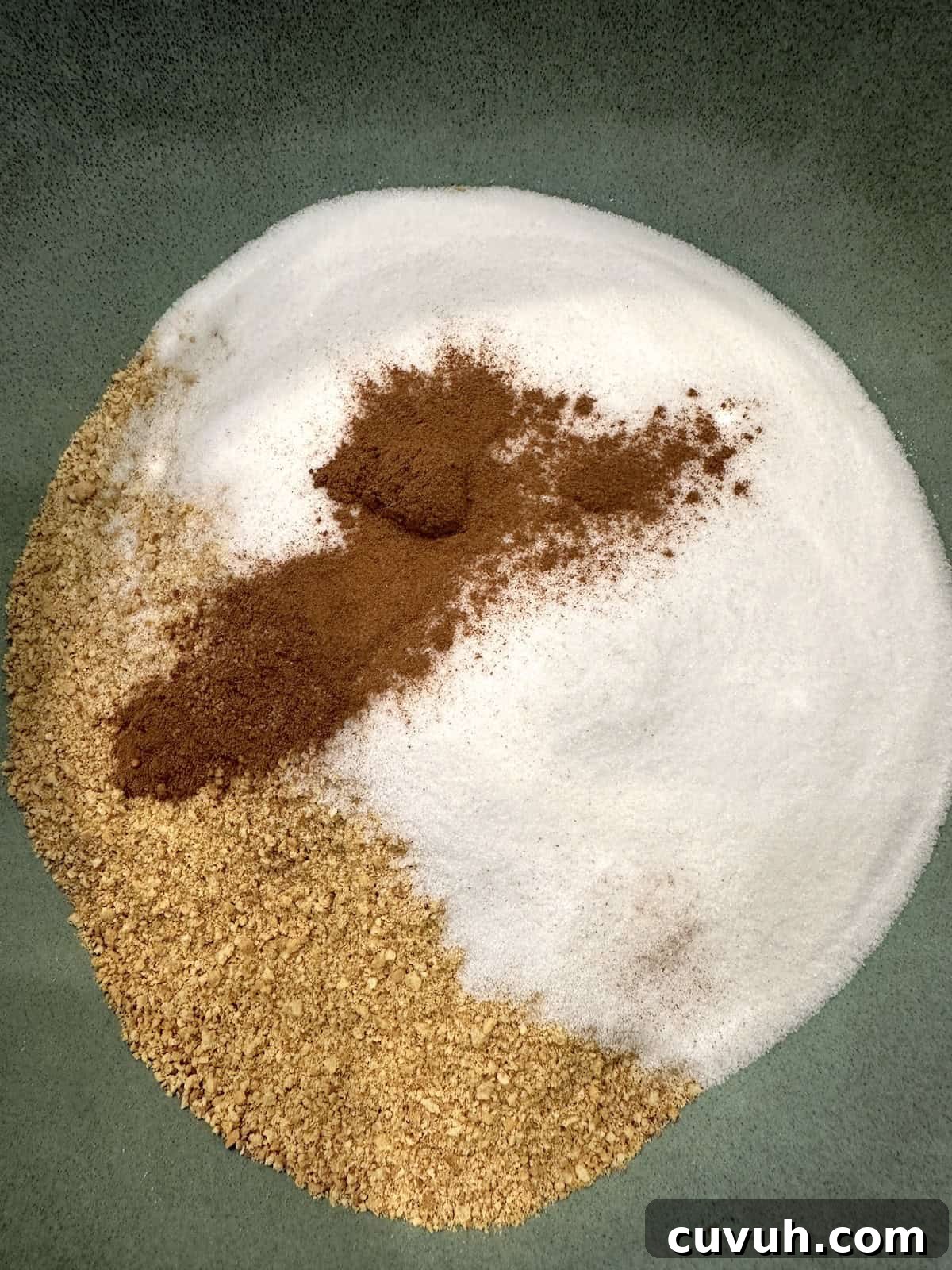 Crushed graham crackers, sugar and cinnamon in a mixing bowl.