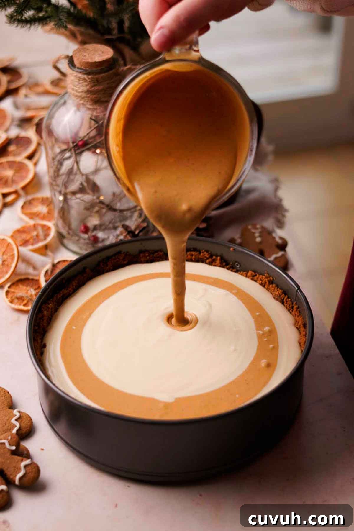Gingerbread Cheesecake Recipe with Spiced Graham Crust 12 swirling the gingerbread cheesecake batter