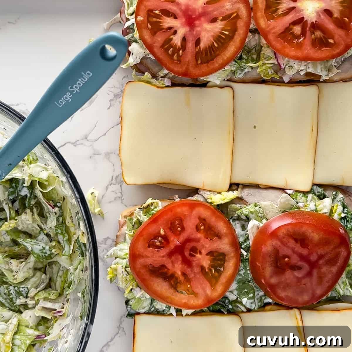 Top Grinder Salad Recipes for Flavorful Sandwiches 7 Lining the sandwich the the salad, meats, cheeses, and tomato.