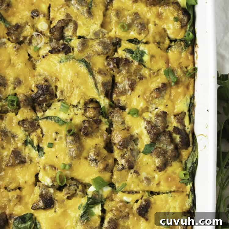 Overhead view of keto breakfast casserole in a white casserole dish, with the casserole cut into squares.