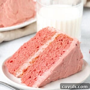 Moist Strawberry Layer Cake with Fresh Strawberry Frosting 11 Slice of strawberry cake with strawberry frosting with glass of milk