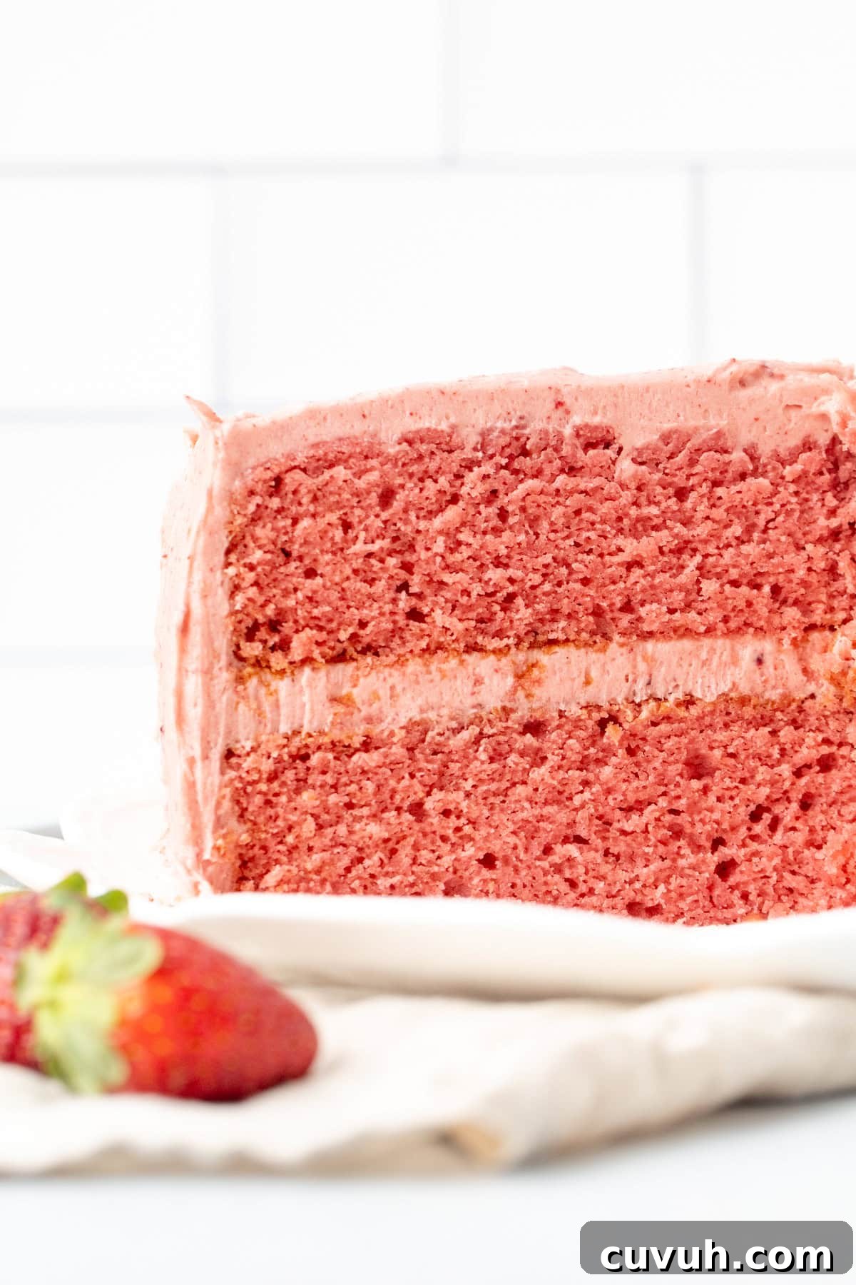 Moist Strawberry Layer Cake with Fresh Strawberry Frosting 3 2-layer strawberry cake with strawberry frosting with slices cut out of cake