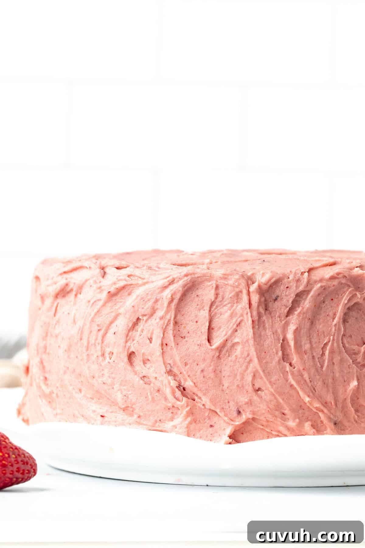 Moist Strawberry Layer Cake with Fresh Strawberry Frosting 9 8-inch round strawberry cake decorated with swirls of pink strawberry buttercream