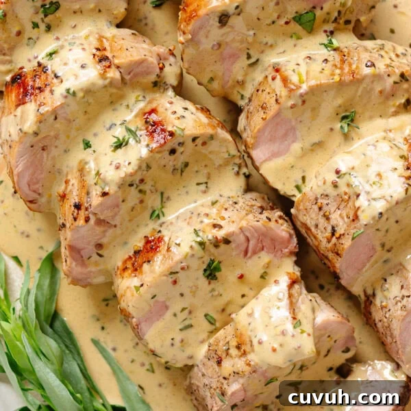 Sliced pork tenderloin with mustard sauce and fresh tarragon.