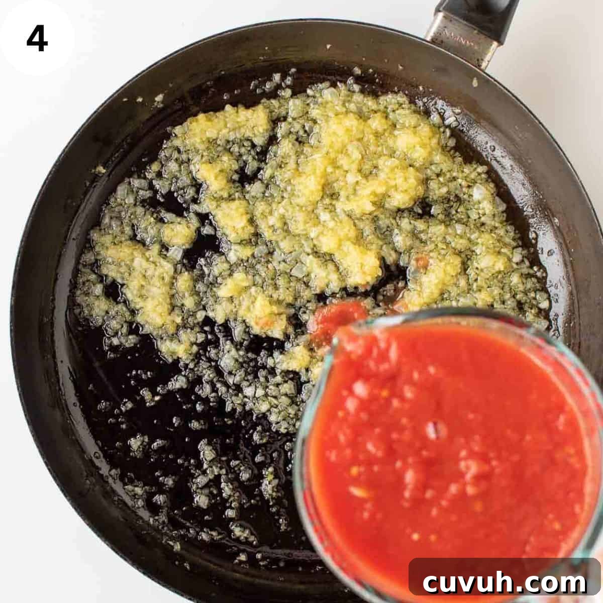 Authentic San Marzano Tomato Sauce Recipe for Homemade Pasta 8 Tomato puree being added to cooked, finely chopped onion.
