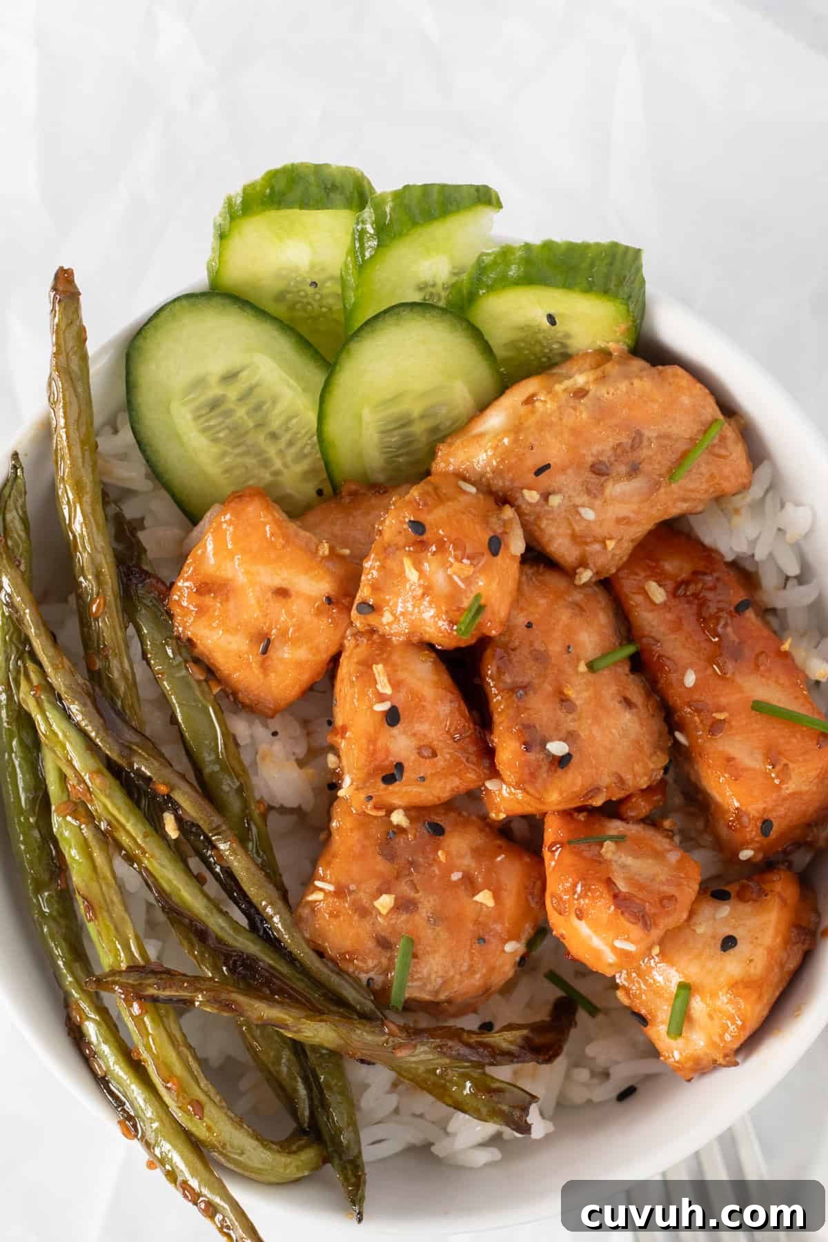 bowl with salmon bites and green veggies over rice.