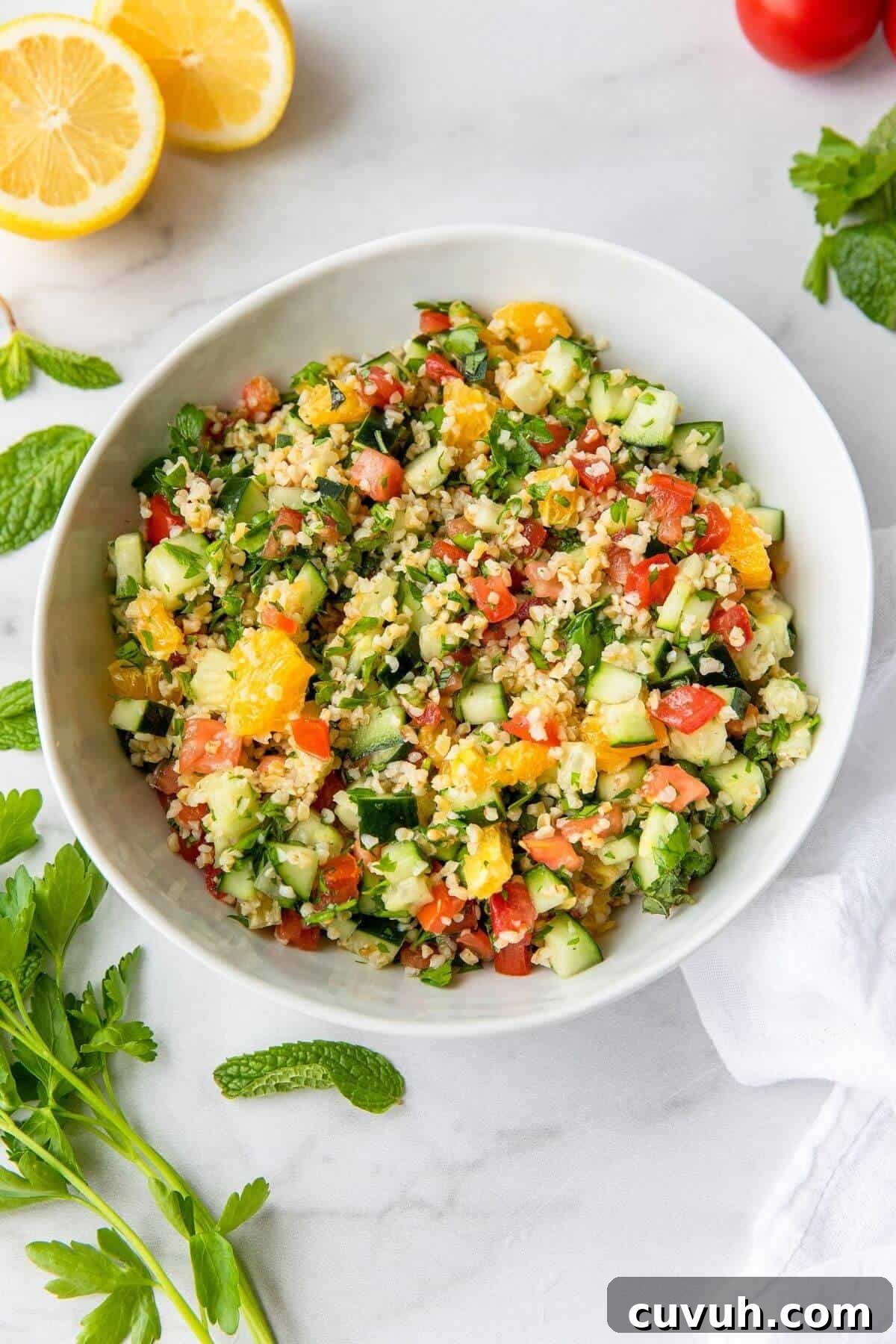 healthy Greek tabbouleh salad with orange, cucumber, and tomato