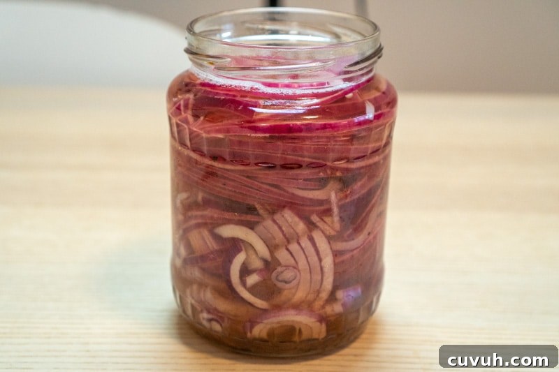 Sugar-Free Quick Pickled Red Onions Recipe for Tangy Flavor 6 Covering the onions with vinegar