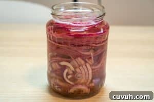 Sugar-Free Quick Pickled Red Onions Recipe for Tangy Flavor 9 Covering the onions with vinegar