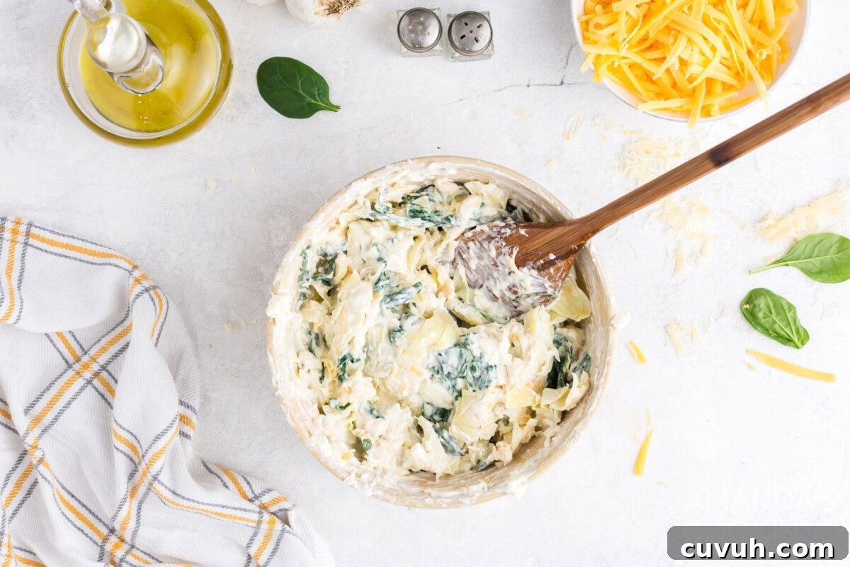 adding in the spinach mixture to bowl