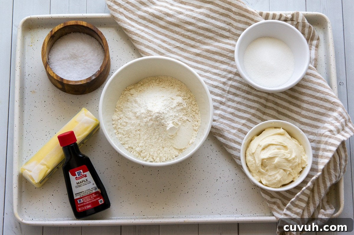 ingredients to make maple shortbread sandwich cookies including frosting, sugar, flour, butter, and maple extract.