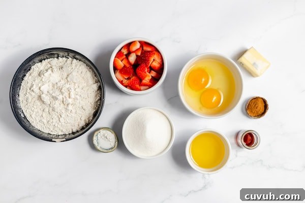 Strawberry Muffins Without Gluten — Quick Soft Recipe 3 Image, taken from above, shows several bowls full of the ingredients to make gluten free strawberry muffins- flour, sugar, eggs, oil, strawberries, butter and seasonings.