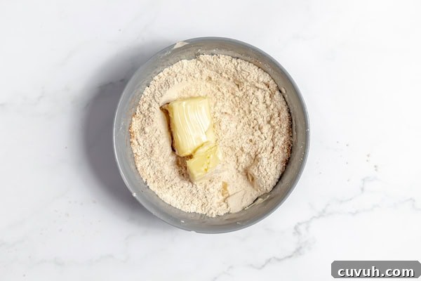Strawberry Muffins Without Gluten — Quick Soft Recipe 4 Image, taken from above, shows a large bowl with the ingredients for streusel topping ready to be mixed together.