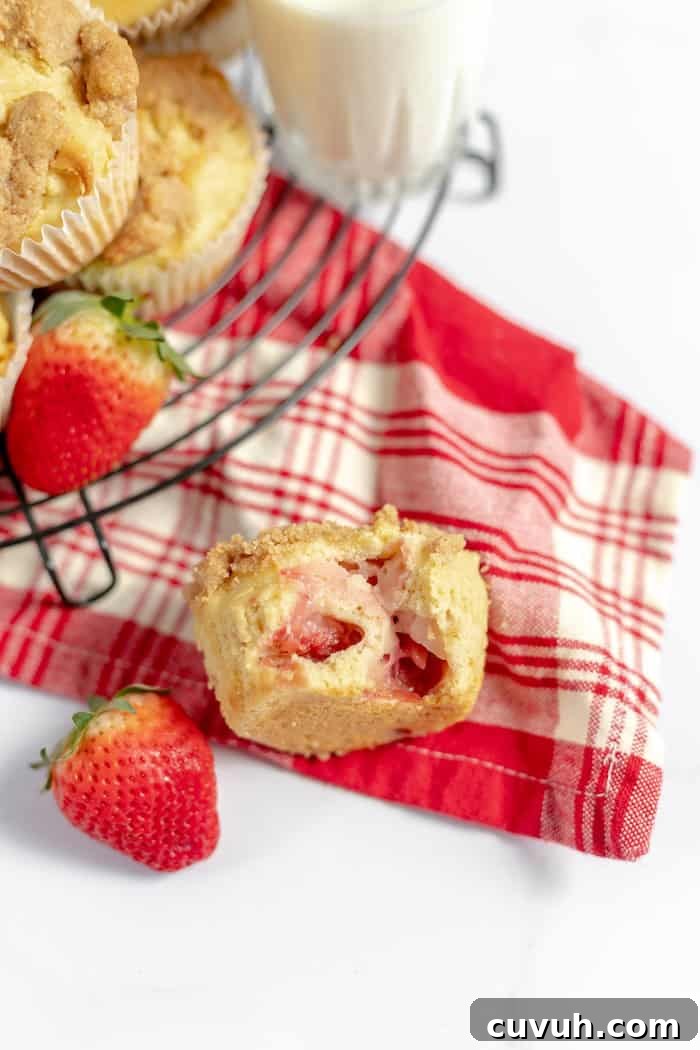 Strawberry Muffins Without Gluten — Quick Soft Recipe 7 Image shows a red and white towel on a table, with muffins on a cooling rack and a glass of milk