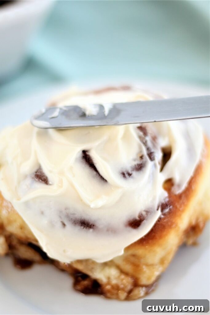 spreading frosting on roll