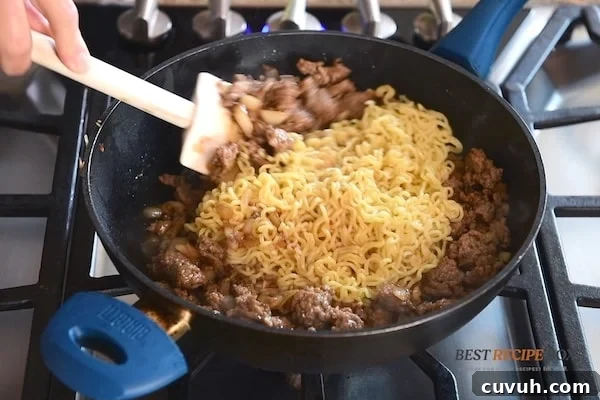 Korean Pork and Kimchi Ramen Stir-Fry Recipe 7 adding noodles