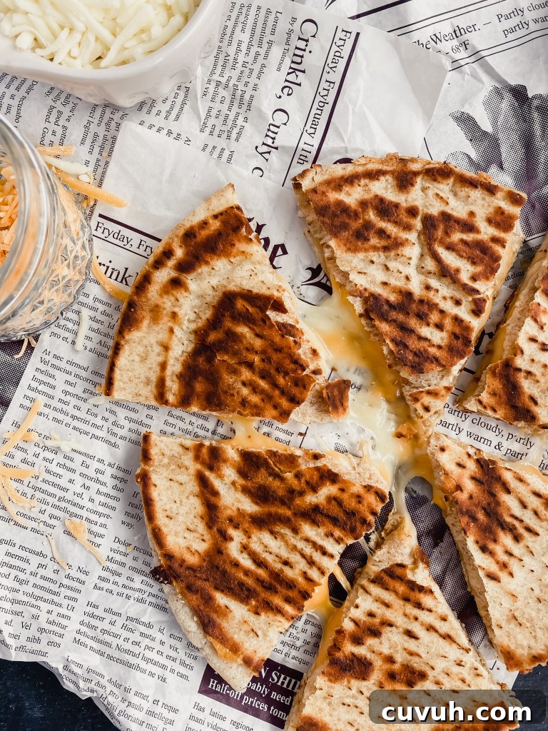 healthy cheese quesadilla sliced into six pieces with melty cheese oozing out.