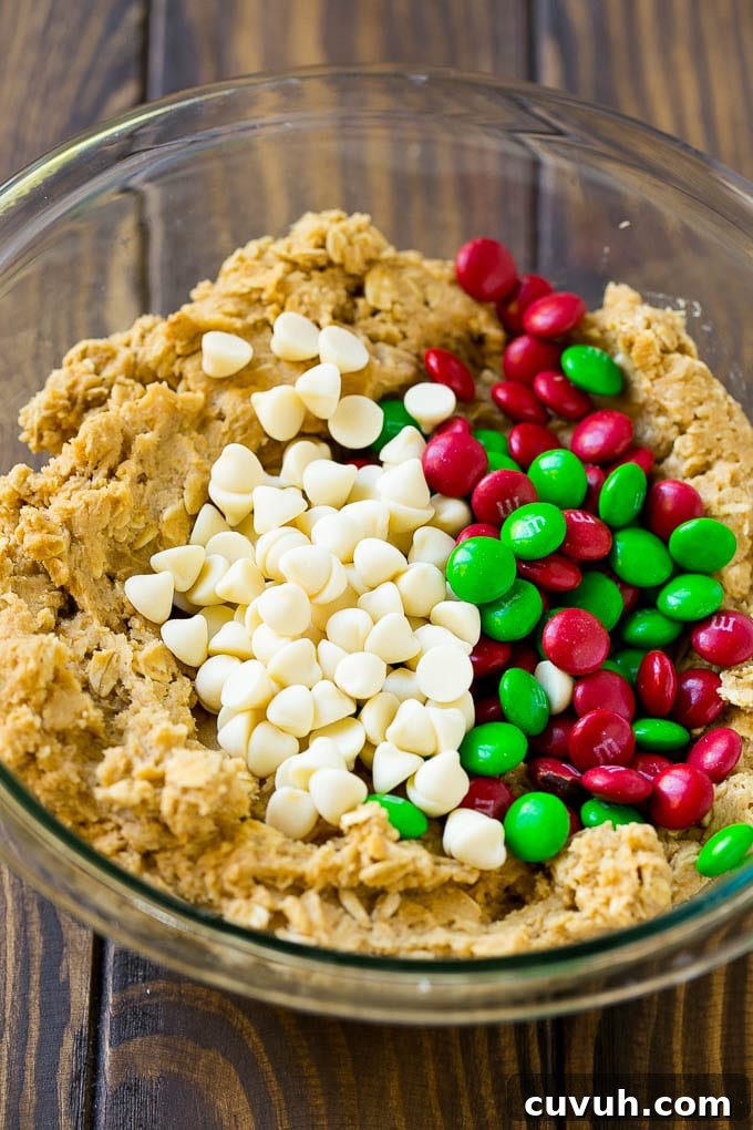 Christmas Monster Cookies Cookie dough with red and green M&M's and white chocolate chips.