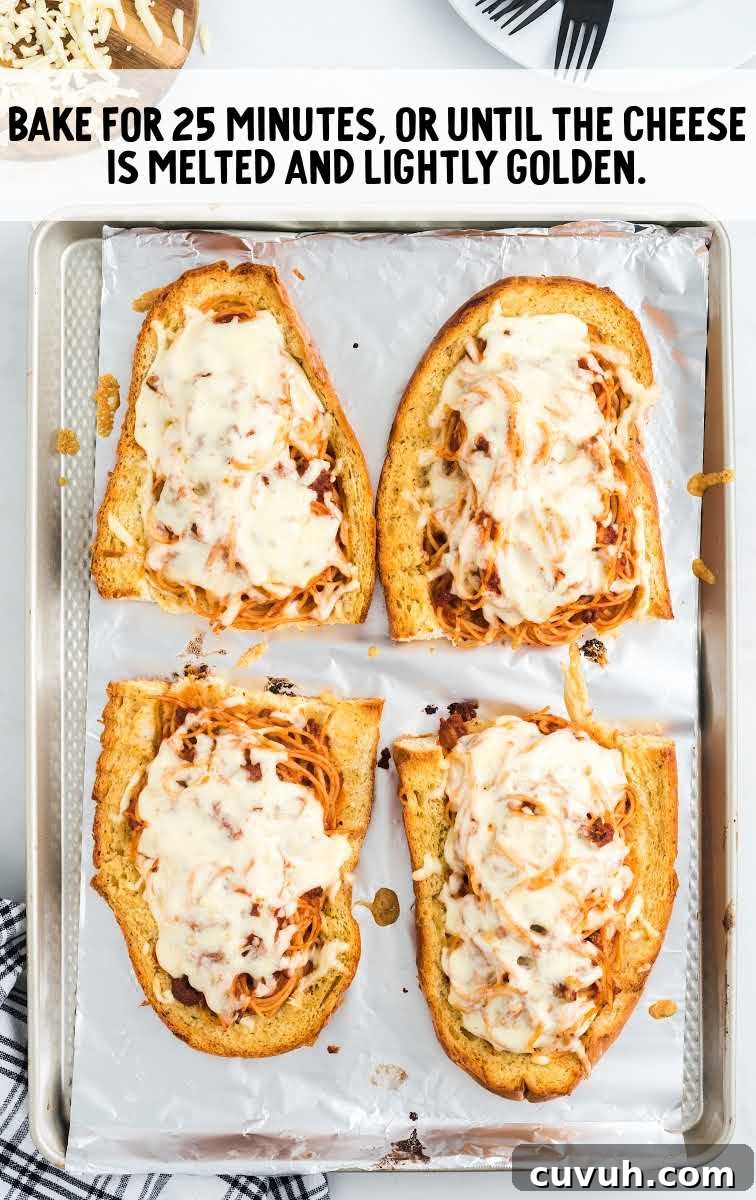 spaghetti stuffed garlic bread process shot after bread has been cooked on a sheet pan