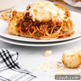 close up shot of a piece of spaghetti stuffed garlic bread on a plate