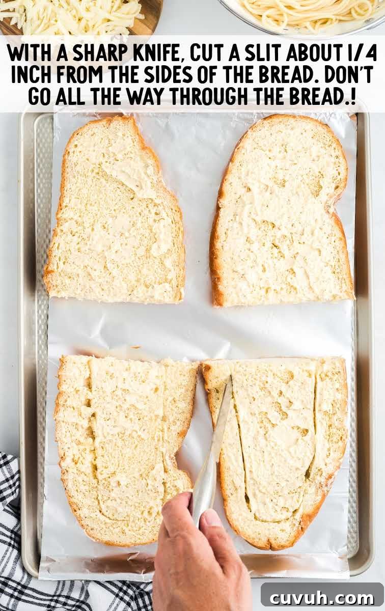spaghetti stuffed garlic bread process shot of slits being cut in bread on a sheet pan