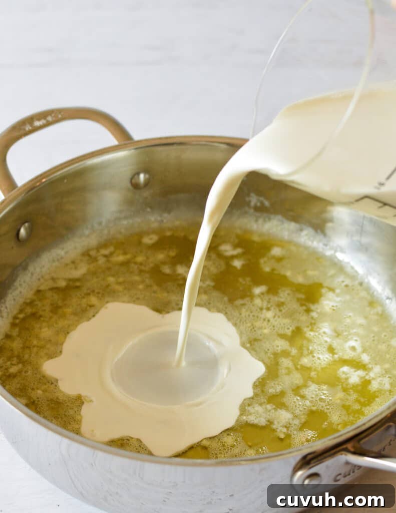 pouring cream into butter in a skillet.