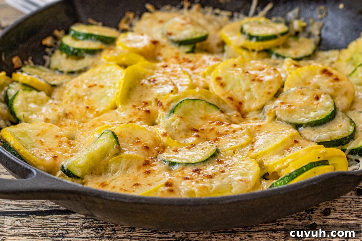 zucchini side dish cooked in a cast iron skillet and topped with parmesan cheese